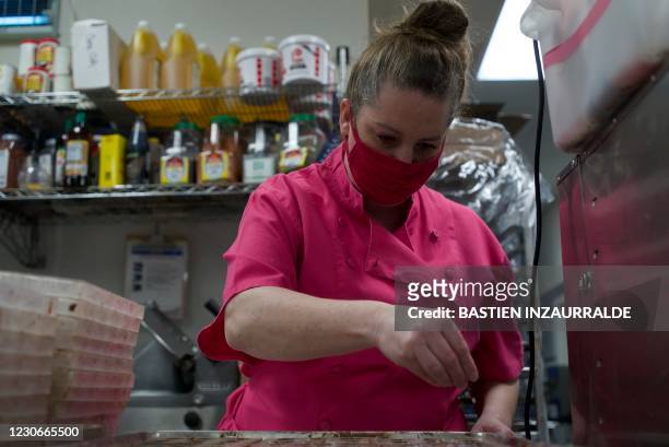 Sarah Dwyer, a chocolatier and owner of Chouquette Chocolates, sprinkles sea salt on chocolate cups in her company's kitchen in Gaithersburg,...