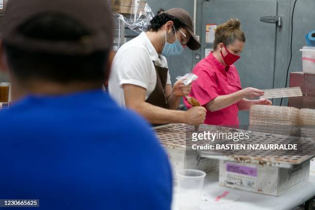 Sarah Dwyer , a chocolatier and owner of Chouquette Chocolates, holds a chocolate mold in her company's kitchen in Gaithersburg, Maryland, on January...