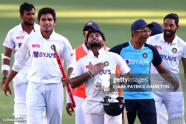 India's batsman Rishabh Pant gestures as team celebrate victory in the fourth cricket Test match against Australia at The Gabba in Brisbane on...