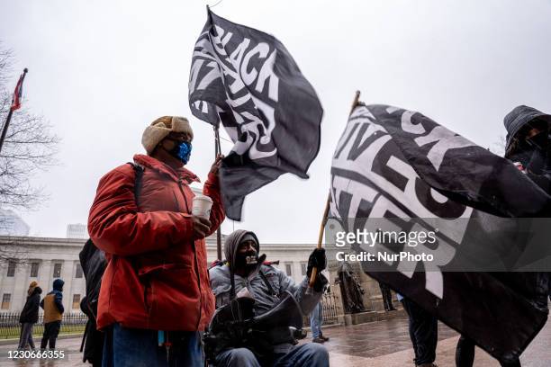 Counter-protestors in support of the Black Lives Matter movement, hold flags in the air towards passing cars during an armed protest at the Ohio...