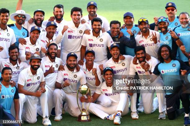 Indian players and officials celebrate with the winning trophy at the end of the fourth cricket Test match between Australia and India at The Gabba...