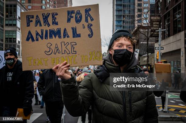 Animal rights activists seen holding signs while marching through the streets of New York. Hundreds of Animal Rights activists targeted the gruesome...