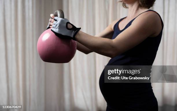 Bonn, Germany In this photo illustration a pregnant woman is doing a cattlebell swing on January 17, 2021 in Bonn, Germany.