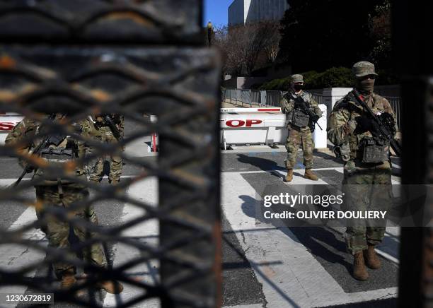 Members of the US National Guard stand at a security area ahead of the 59th inaugural ceremony for President-elect Joe Biden and Vice President-elect...