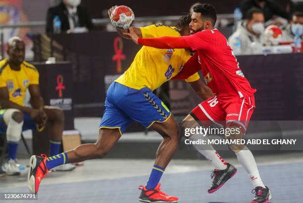 Democratic Republic of Congo's left wing Aurelien Tchitombi challenges Bahrain's right winger Ahmed Abbas during the 2021 World Men's Handball...