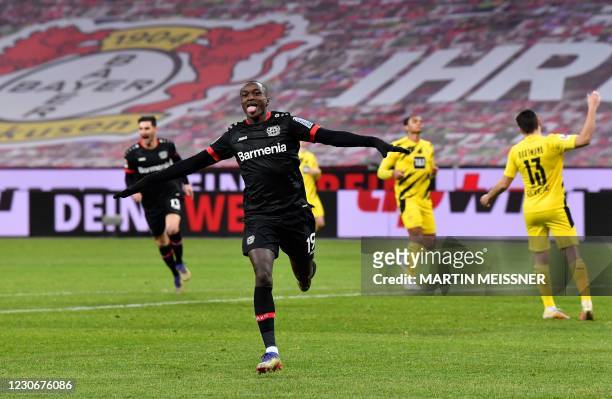 Leverkusen's French forward Moussa Diaby celebrates scoring the opening goal during the German first division Bundesliga football match Bayer 04...