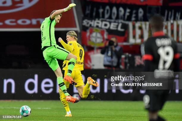 Leverkusen's Finnish goalkeeper Lukas Hradecky comes out to prevent Dortmund's Norwegian forward Erling Braut Haaland from scoring during the German...