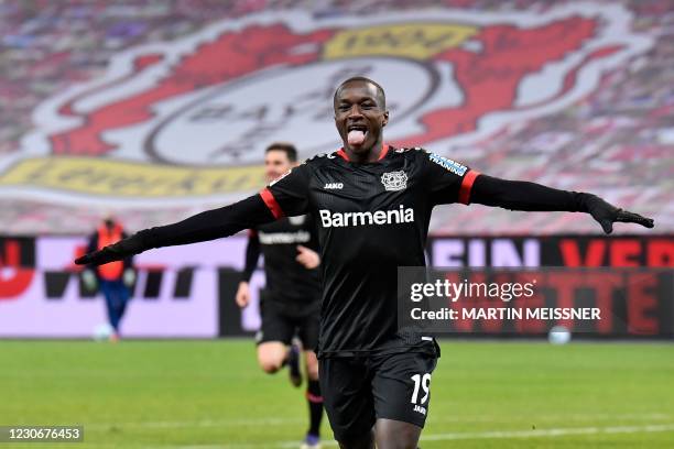 Leverkusen's French forward Moussa Diaby celebrates scoring the opening goal during the German first division Bundesliga football match Bayer 04...