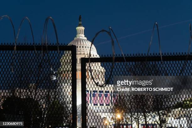 Security fence topped by concertina wire surrounds the grounds of the US Capitol Building in Washington, DC on January 19 ahead of the 59th inaugural...