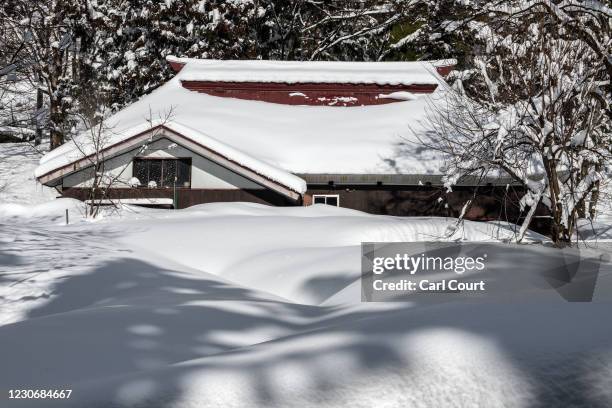 House is partially submerged in snow on January 20, 2021 in Joetsu, Japan. Parts of northern Japan have been hit by unexpectedly heavy snow in recent...