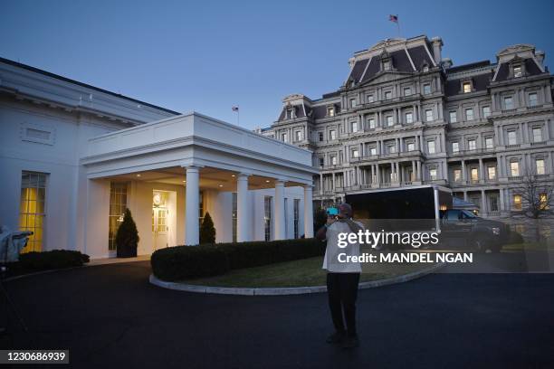 Staff member takes a photo in front of the West Wing of the White House on US President Donald Trump's final day in office on January 20, 2021 in...