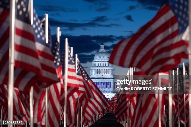 Flags are seen in the early morning as preparations continue for the inauguration of US President-elect Joe Biden on January 20 at the US Capitol in...