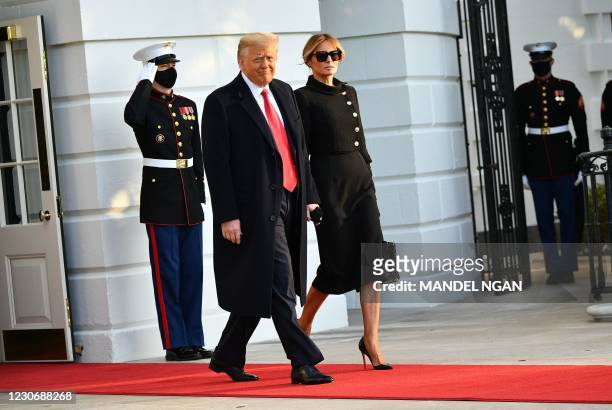 President Donald Trump and First Lady Melania make their way to board Marine One before departing from the South Lawn of the White House in...