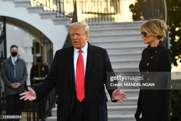 Outgoing US President Donald Trump and First Lady Melania Trump speak to the media depart the White House in Washington, DC, on January 20, 2021. -...