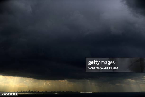 Picture taken on January 20, 2021 shows a dark cloud over the Lebanese coastal city of Jounieh, north of the capital Beirut, on a stormy day in the...