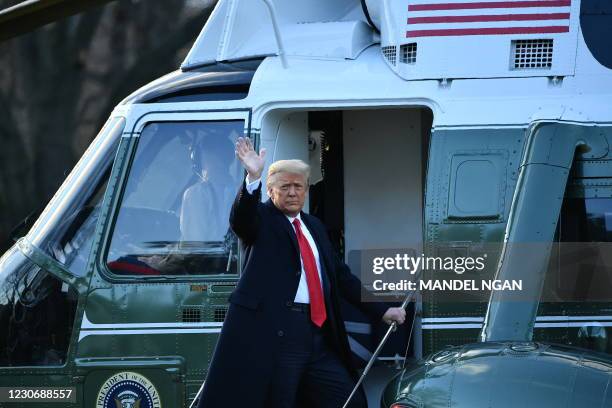 Outgoing US President Donald Trump waves as he boards Marine One at the White House in Washington, DC, on January 20, 2021. President Trump travels...