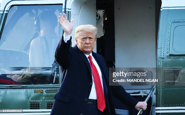 Outgoing US President Donald Trump waves as he boards Marine One at the White House in Washington, DC, on January 20, 2021. - President Trump travels...