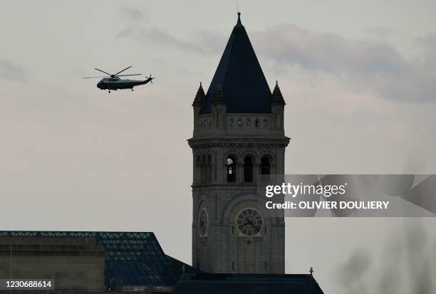 Marine One with US President Donald Trump and First Lady Melania Trump passes the Trump International Hotel as it departs the White House in...