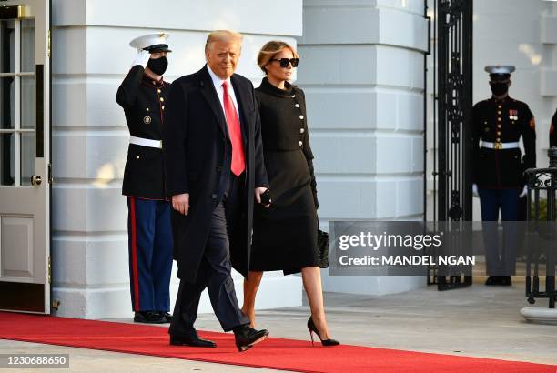 President Donald Trump and First Lady Melania make their way to board Marine One before departing from the South Lawn of the White House in...