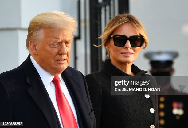 President Donald Trump and First Lady Melania Trump make their way to board Marine One as they depart the White House in Washington, DC, on January...