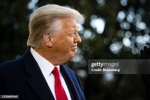 President Donald Trump smiles while speaking to members of the media before boarding Marine One on the South Lawn of the White House in Washington,...