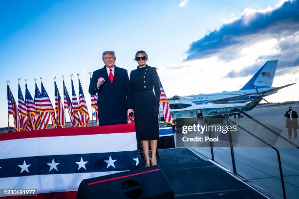 President Donald Trump and First Lady Melania Trump acknowledge supporters at Joint Base Andrews before boarding Air Force One for his last time as...