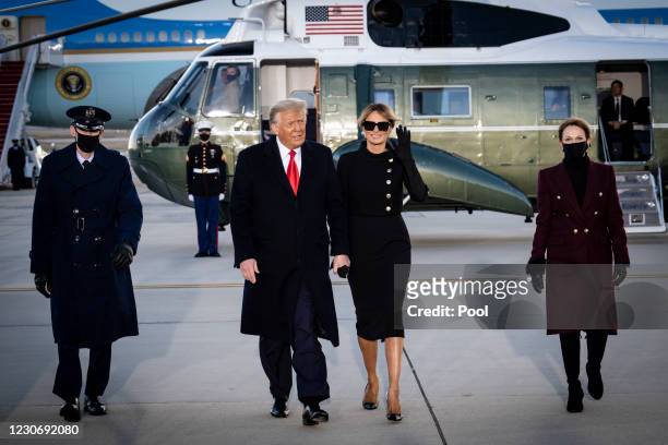 President Donald Trump and First Lady Melania Trump acknowledge waiting supporters at Joint Base Andrews before boarding Air Force One for his last...