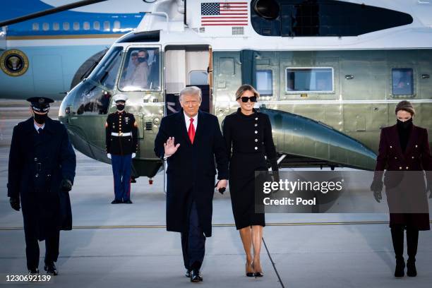 President Donald Trump and First Lady Melania Trump acknowledge waiting supporters at Joint Base Andrews before boarding Air Force One for his last...