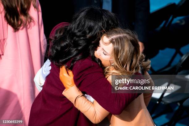 Finnegan Biden hugs Michelle Obama as they arrive before US president-elect Joe Biden is sworn in as the 46th US President on January 20 at the US...