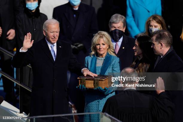 Washington , DC U.S. President-elect Joe Biden takes the oath of office from Supreme Court Chief Justice John Roberts as his wife U.S. First...