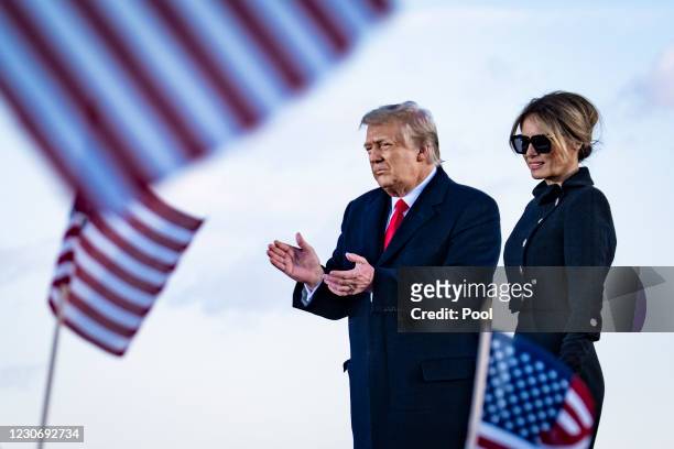 President Donald Trump and First Lady Melania Trump on stage after speaking to supporters at Joint Base Andrews before boarding Air Force One for his...