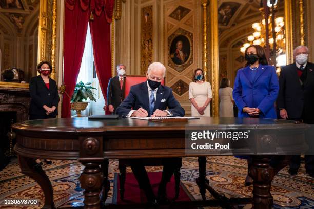 President Joe Biden signs three documents including an Inauguration declaration, cabinet nominations and sub-cabinet noinations, as US Vice President...
