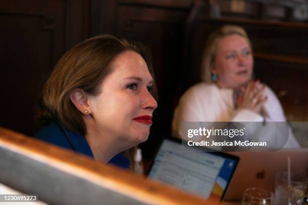 Abigail Derr tears up watching the televised Presidential Inauguration ceremony at Manuel's Tavern on January 20, 2021 in Atlanta, Georgia. During...