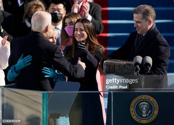 President Joe Biden is congratulated by First lady Jill Biden and his family, after being sworn-in during the 59th inaugural ceremony on the West...