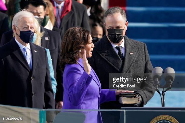 Kamala Harris is sworn in as vice president by Supreme Court Justice Sonia Sotomayor as her husband Doug Emhoff holds the Bible during the the 59th...