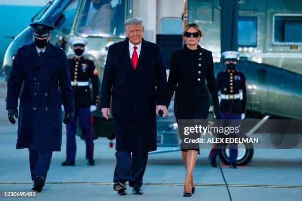 Outgoing US President Donald Trump and First Lady Melania Trump step out of Marine One at Joint Base Andrews in Maryland on January 20, 2021. -...