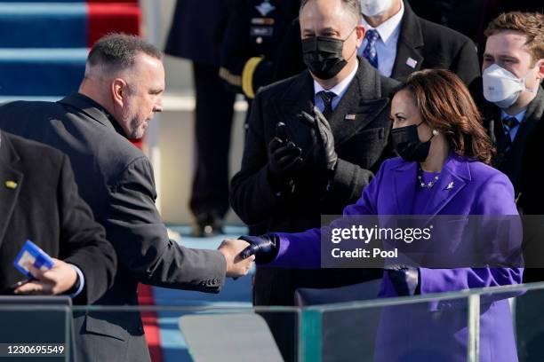 Garth Brooks shakes Vice President Kamala Harriss hand after singing Amazing Grace during the the 59th inaugural ceremony on the West Front of the...