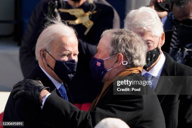 President Joe Biden talks with former Presidents George Bush and Bill Clinton after the the 59th inaugural ceremony on the West Front of the U.S....