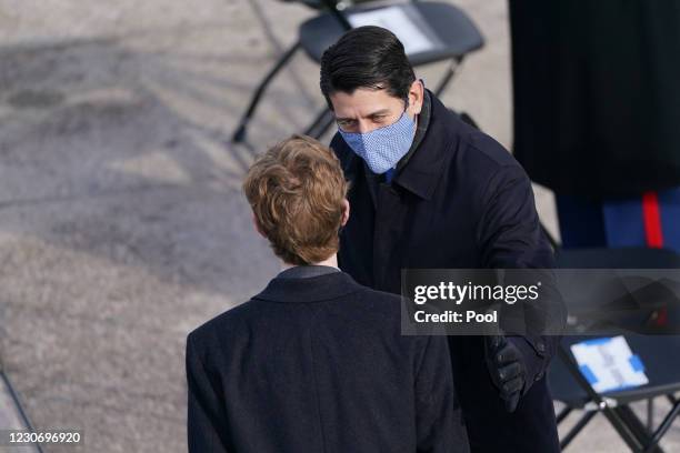 Former House Speaker Paul D. Ryan speaks to a guest during the inauguration of Joe Biden on the West Front of the U.S. Capitol on January 20, 2021 in...