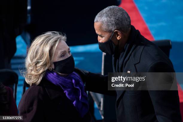 Former Secretary of State Hillary Clinton and former President Barack Obama talk at the end of the inauguration of U.S. President-elect Joe Biden on...