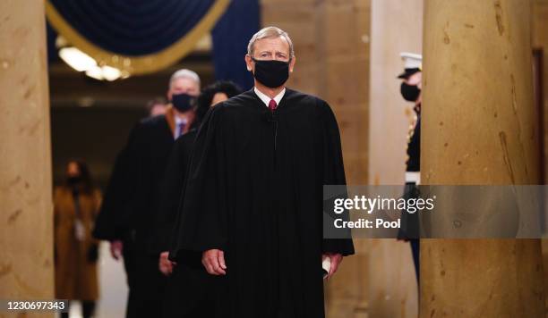 Chief Justice John Roberts leads the US Supreme Court Justices as they arrive in the Crypt of the US Capitol for President-elect Joe Biden's...