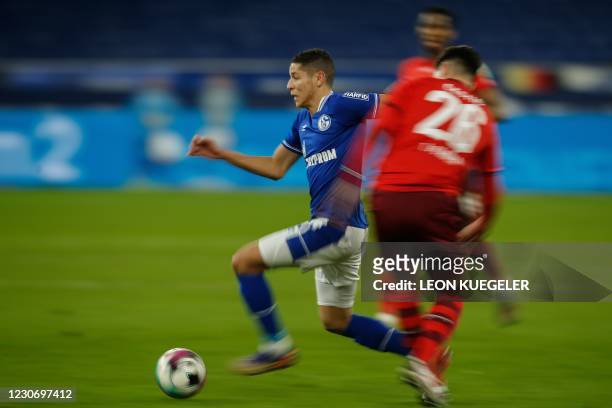 Schalke's French midfielder Amine Harit runs with the ball past Cologne's German defender Sava-Arangel Cestic during the German first division...