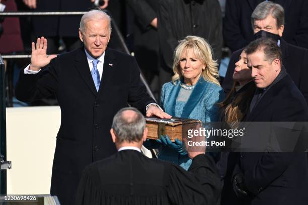 President-elect Joe Biden is sworn in as his wife Jill Biden holds the Bible during the 59th Presidential Inauguration at the U.S. Capitol on January...