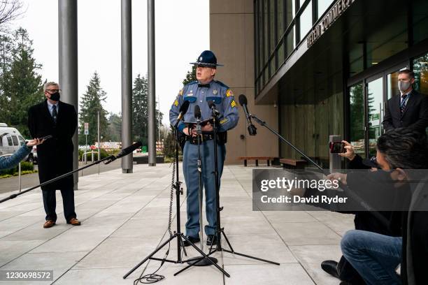 Sergeant Darren Wright, public information officer with the Washington State Patrol, speaks during a press conference near the Washington State...