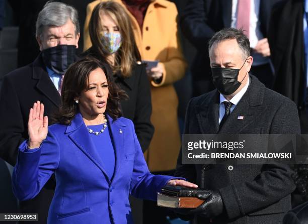 Kamala Harris, flanked by her husband Doug Emhoff, is sworn in as the 49th US Vice President by Supreme Court Justice Sonia Sotomayor on January 20...