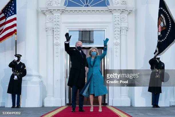 President Joe Biden and first lady Dr. Jill Biden wave as they arrive at the North Portico of the White House, on January 20 in Washington, DC....