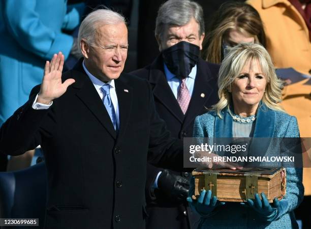 Joe Biden, flanked by incoming US First Lady Jill Biden takes the oath of office as the 46th US President by Supreme Court Chief Justice John Roberts...