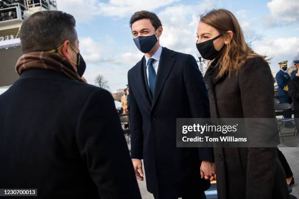 Sen.-elect Jon Ossoff, D-Ga., center, and his wife Dr. Alisha Kramer, attend the inauguration before Joe Biden was sworn in as the 46th President of...