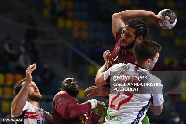 Portugal's left back Andre Gomes shoots challnged by Norway's right back Harald Reinkind during the 2021 World Men's Handball Championship between...