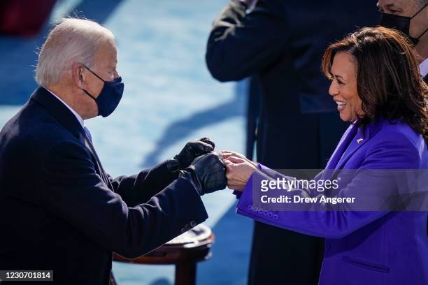 President-elect Joe Biden fist bumps newly sworn-in Vice President Kamala Harris after she took the oath of office on the West Front of the U.S....